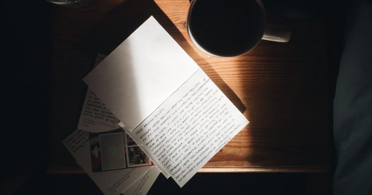 A notebook lays on a sunny desk in an example of a journaling session for mental health benefits.