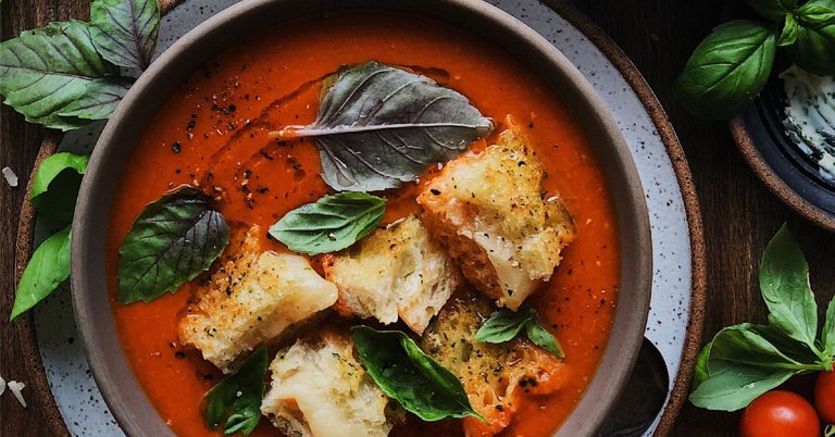 A bowl of tomato soup is cooked slowly in an example of the slow food movement.