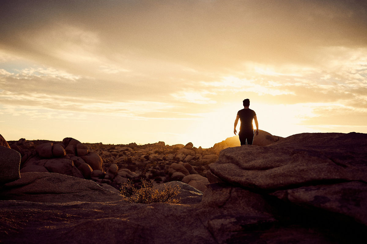 A figure on a mountain at sunrise during the spring equinox.