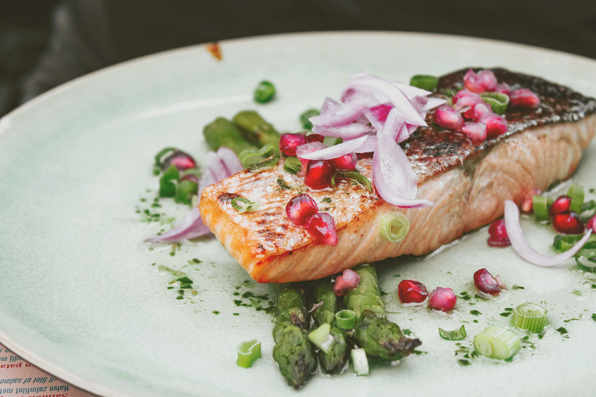 A slice of salmon topped with veggies during a spring equinox meal.