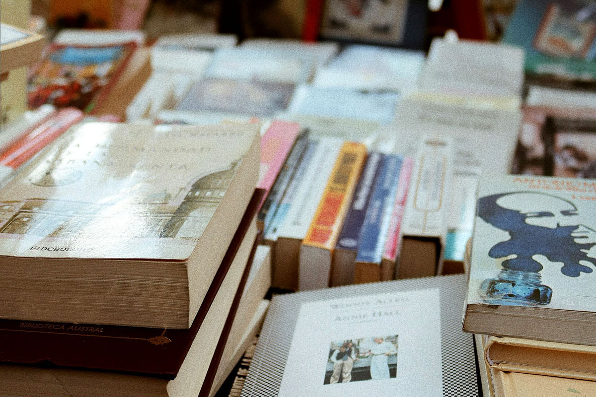 A book stand is piled with rows of books and novels. 