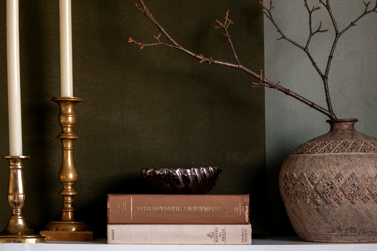 A stack of books lay on a shelf.