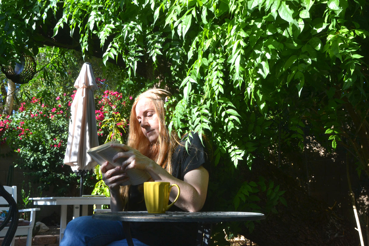 Dee reads in the garden during a slow and simple summer morning.