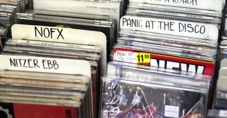 Rows of CDs for sale at a record store as an example of the gen x analog lifestyle.