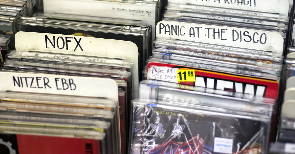 Rows of CDs for sale at a record store as an example of the gen x analog lifestyle.