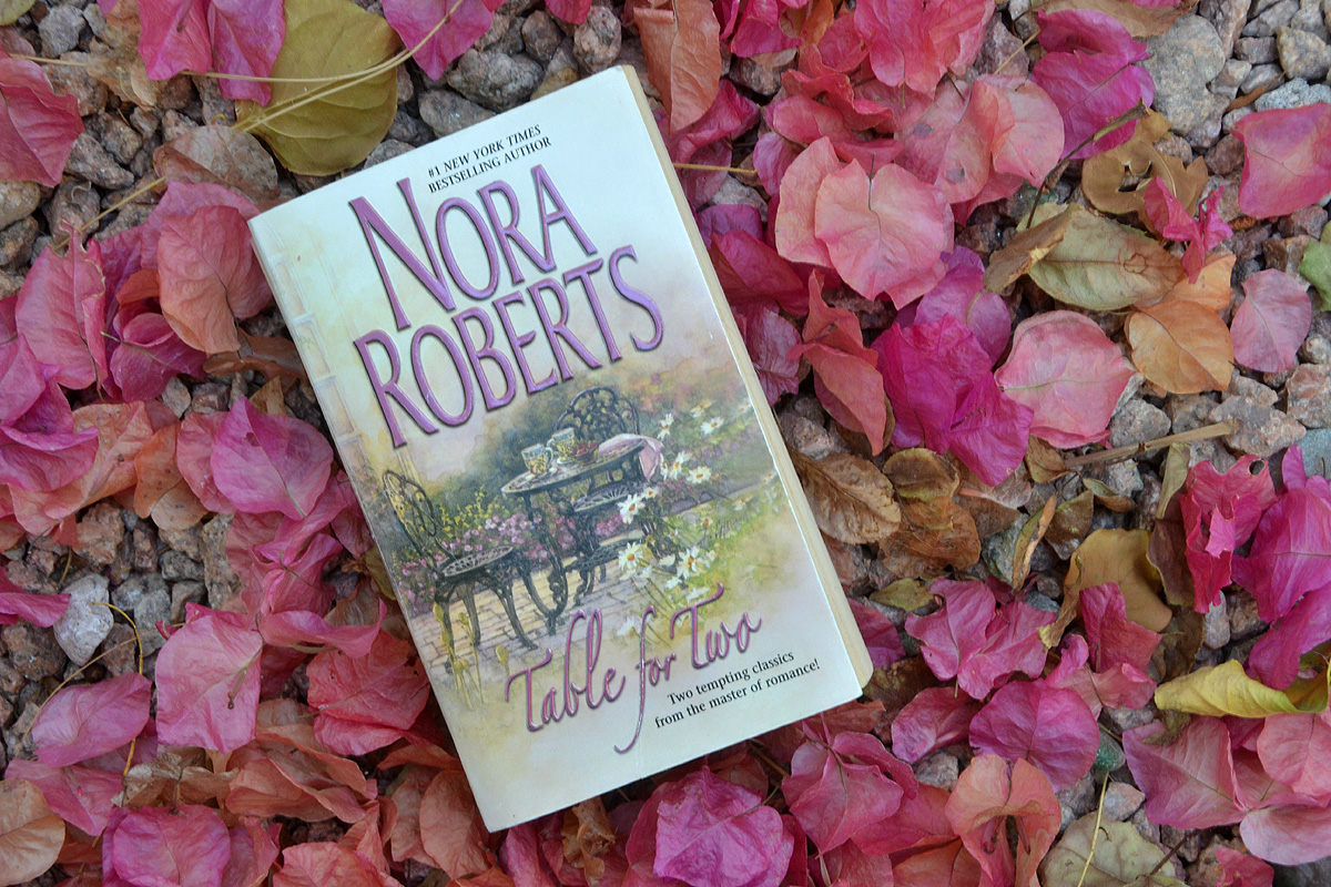 A Nora Roberts novel laying in pink petals.  